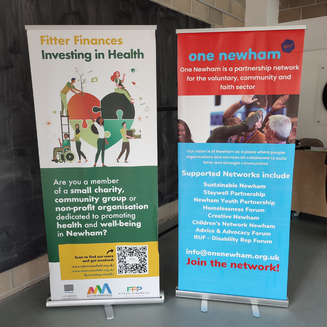 Two pull-up banners, one with the Fitter Finances information, the other with the One Newham information